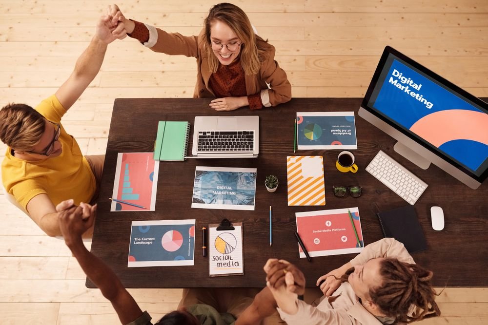 Colleagues celebrating success in a digital marketing office